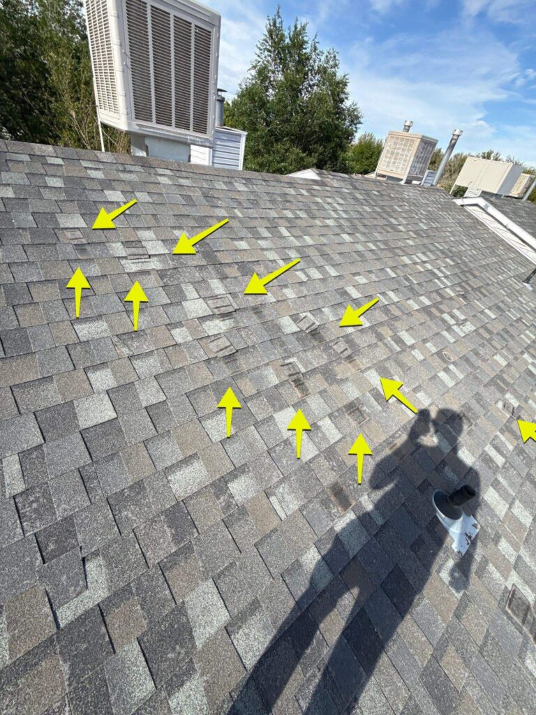 Storm damage restoration in St. George, UT — hail impacts marked during a roof inspection for an insurance claim